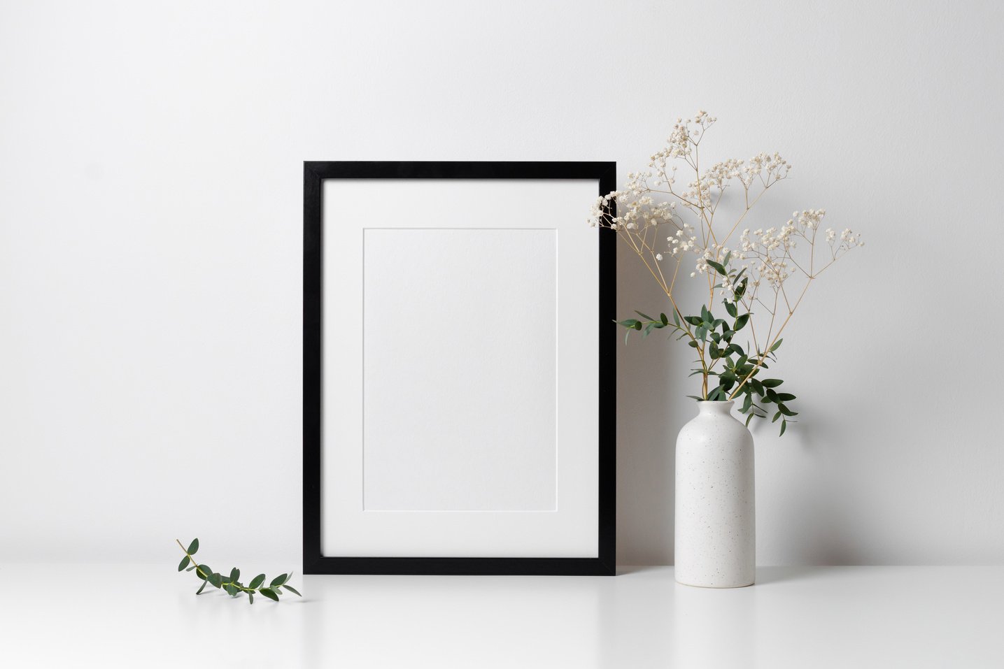 Portrait frame mockup with botanical decor